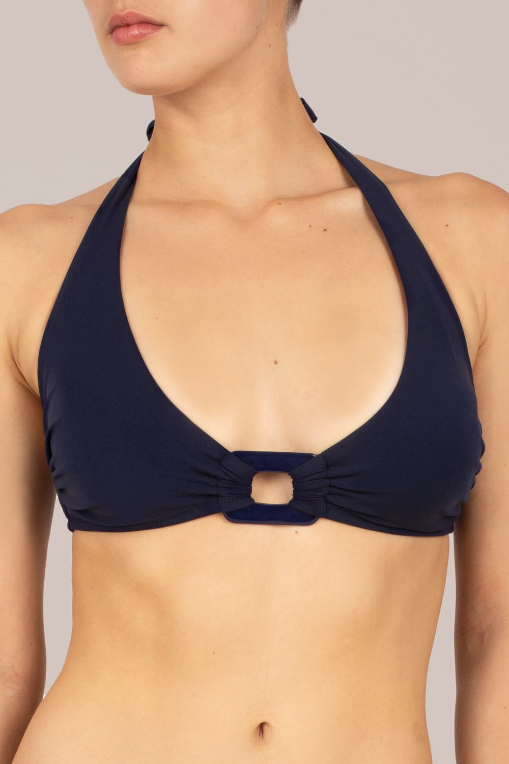 Close-up of halter neck bikini top on KIKKI-G Beatrice navy blue halter neck bikini with rectangle retro trim and subtle lift