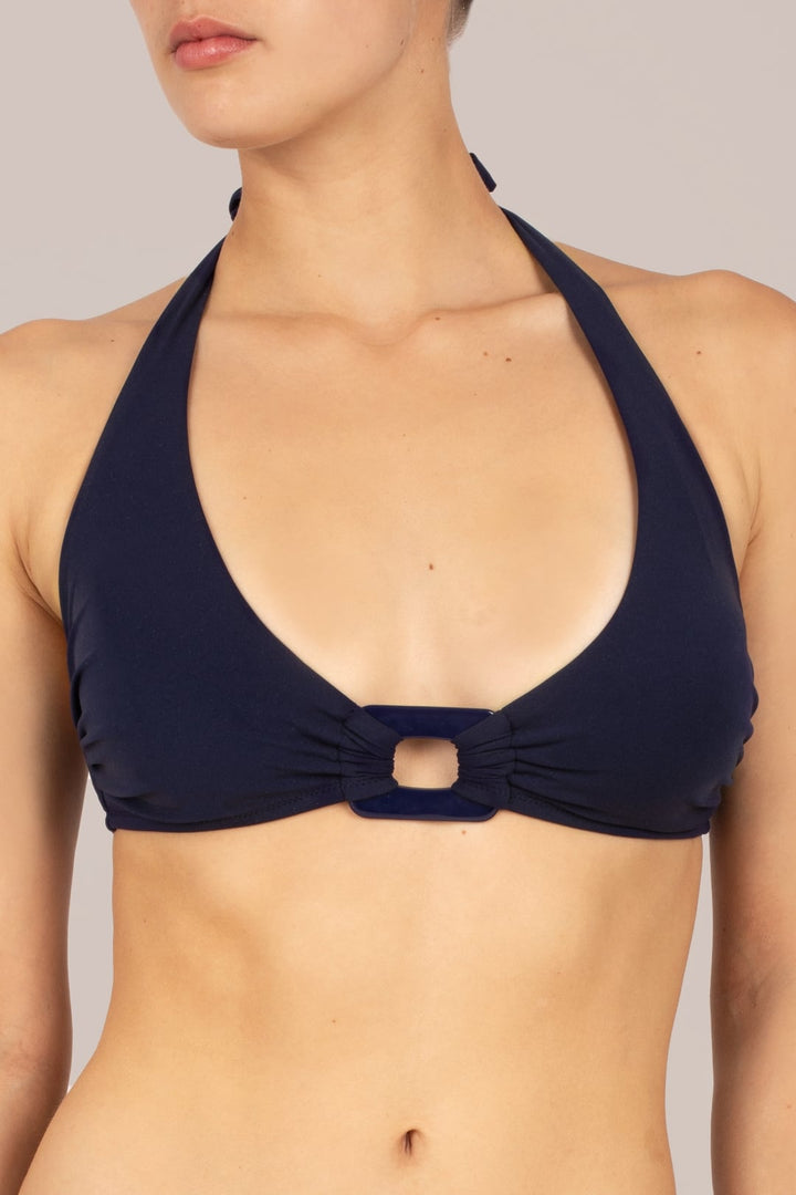 Close-up of halter neck bikini top on KIKKI-G Beatrice navy blue halter neck bikini with rectangle retro trim and subtle lift